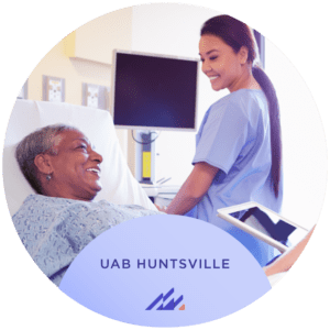 Image of nurse next to patient in hospital bed.