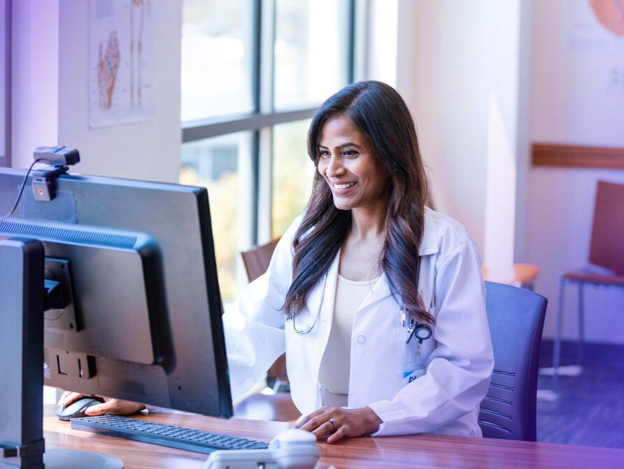 Doctor at computer using EHR tool