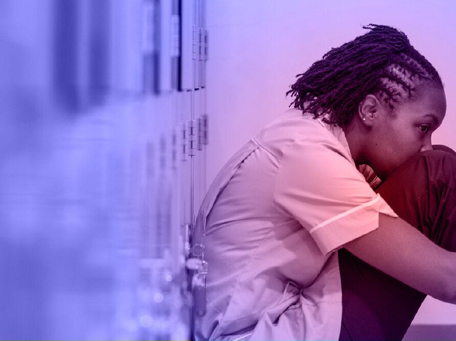 girl sitting on floor hugging legs