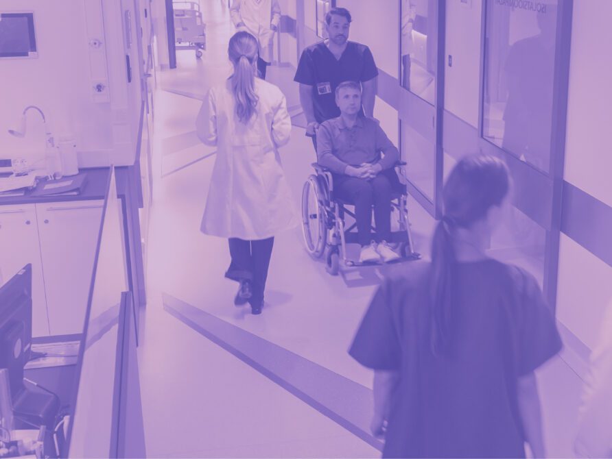 Doctor pushing patient in wheelchair