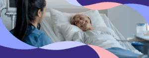 Nurse talking to patient in hospital bed