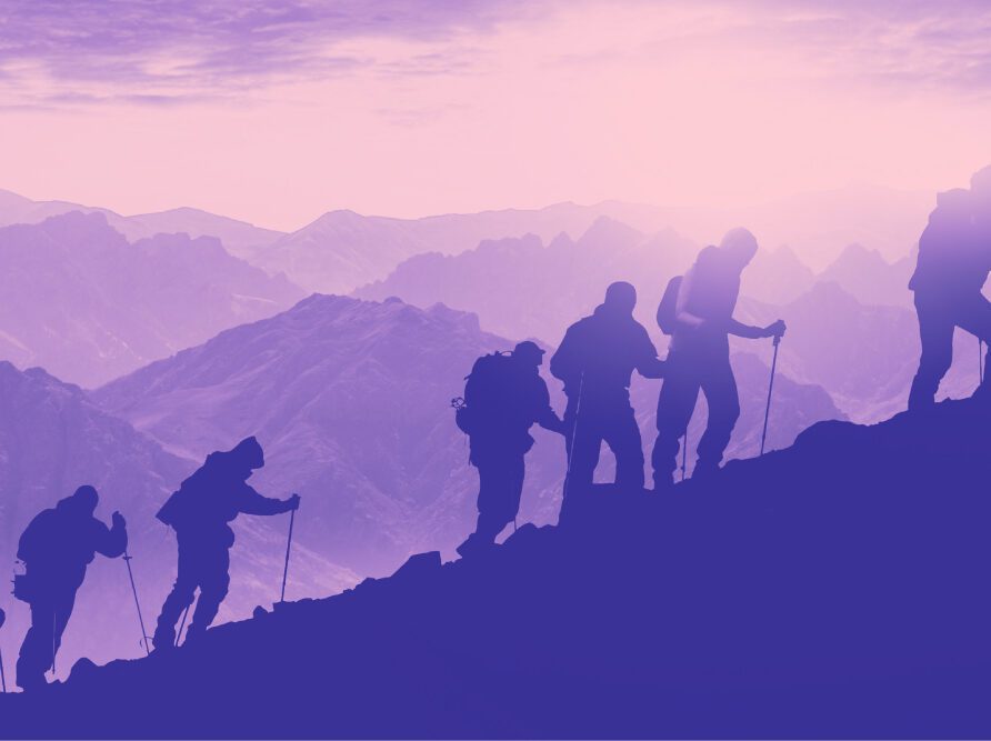 Hikers climbing up mountain
